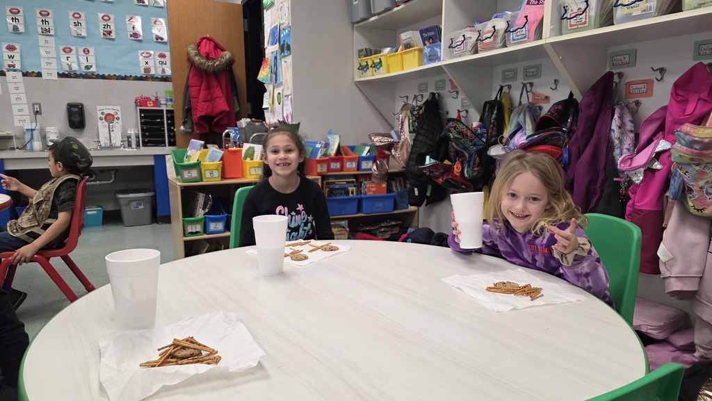 Image of students enjoying snacks in the classroom during their hot chocolate party that they earned for positive behavior choices.