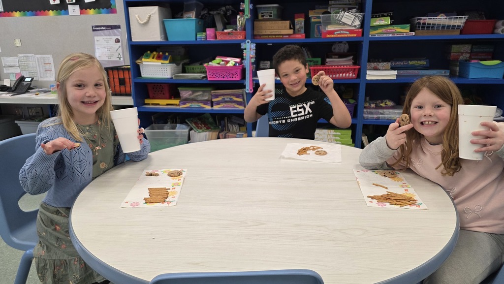 Image of students enjoying snacks in the classroom during their hot chocolate party that they earned for positive behavior choices.
