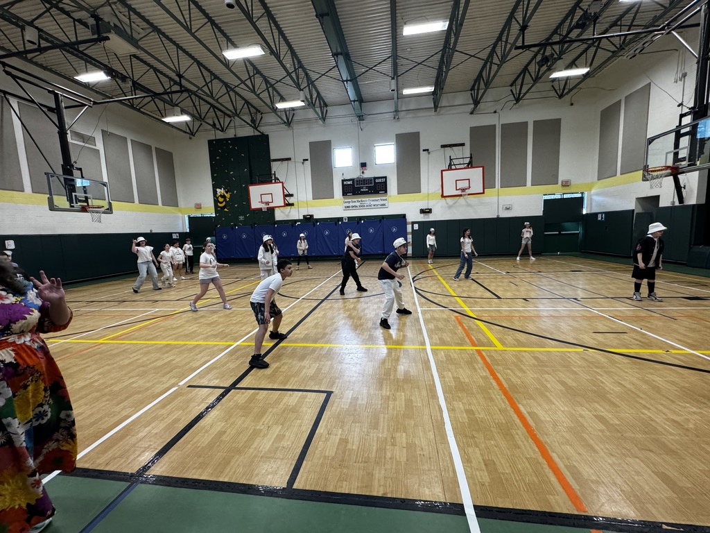 image of student in a gym playing kickball