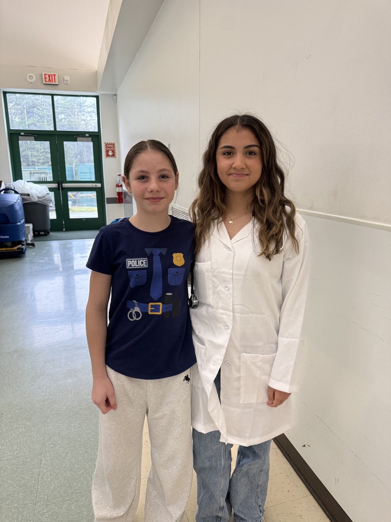Image of students dressed up in costumes of what they want to be when they grow up. Shown here is a doctor and a police officer