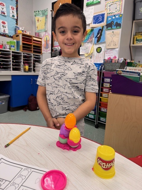 Image of a student posing with his egg stem activity
