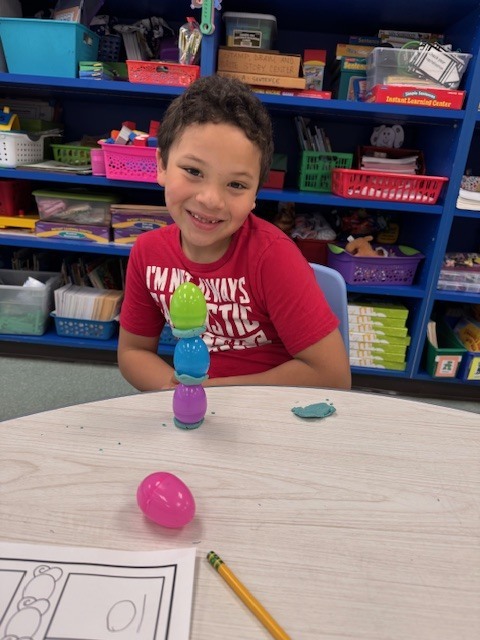 Image of a student posing with his egg stem activity