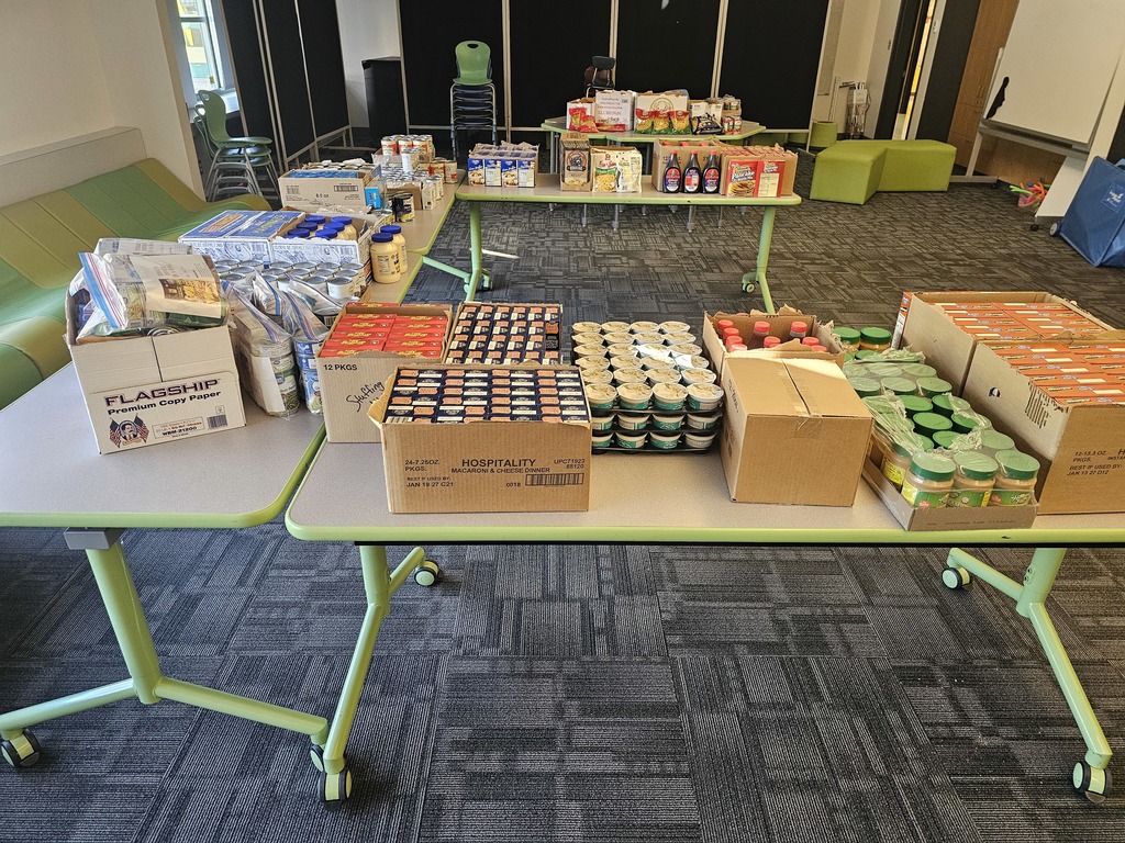 Image of dry packaged goods set out on tables for a community food pantry