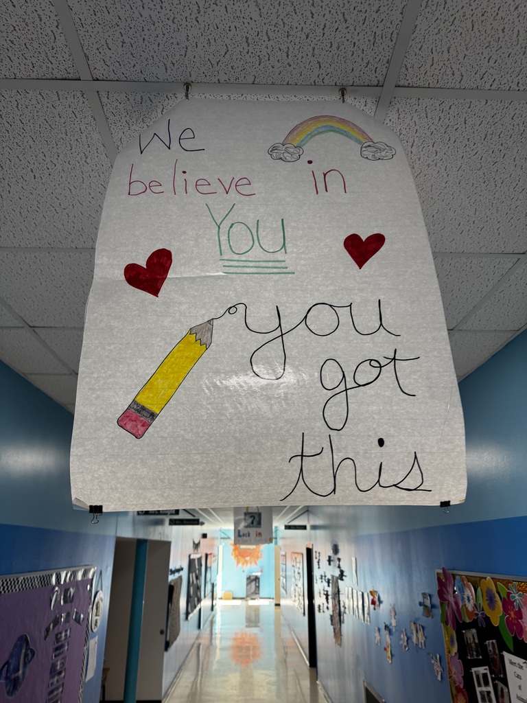Image of a poster hanging from the ceiling of a school hallway that reads "We Believe In You, You Got This"