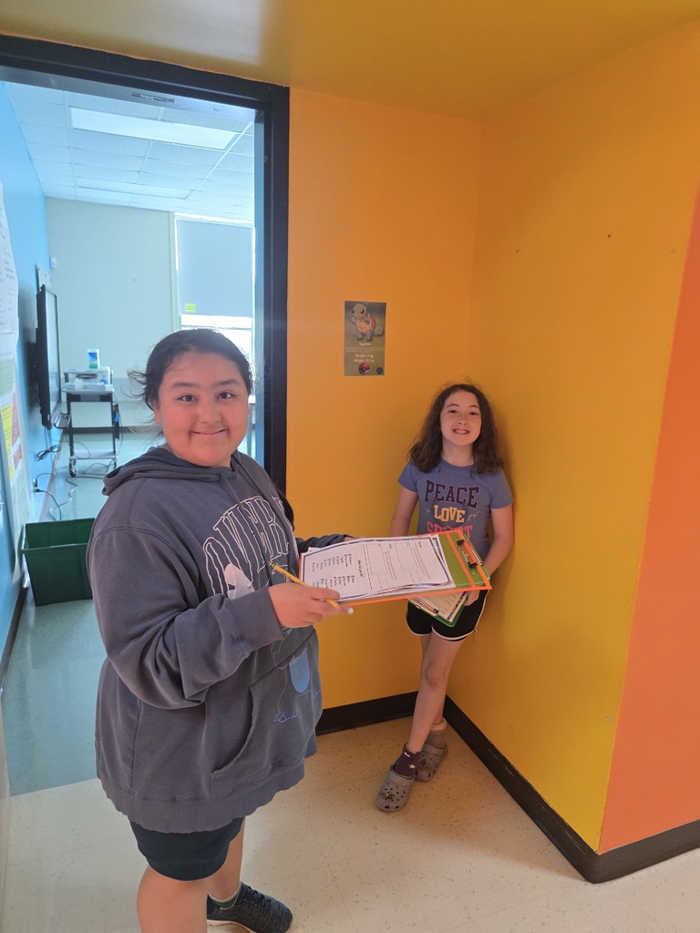 Image of students in a school hallway looking for Pokemon for a math assignment