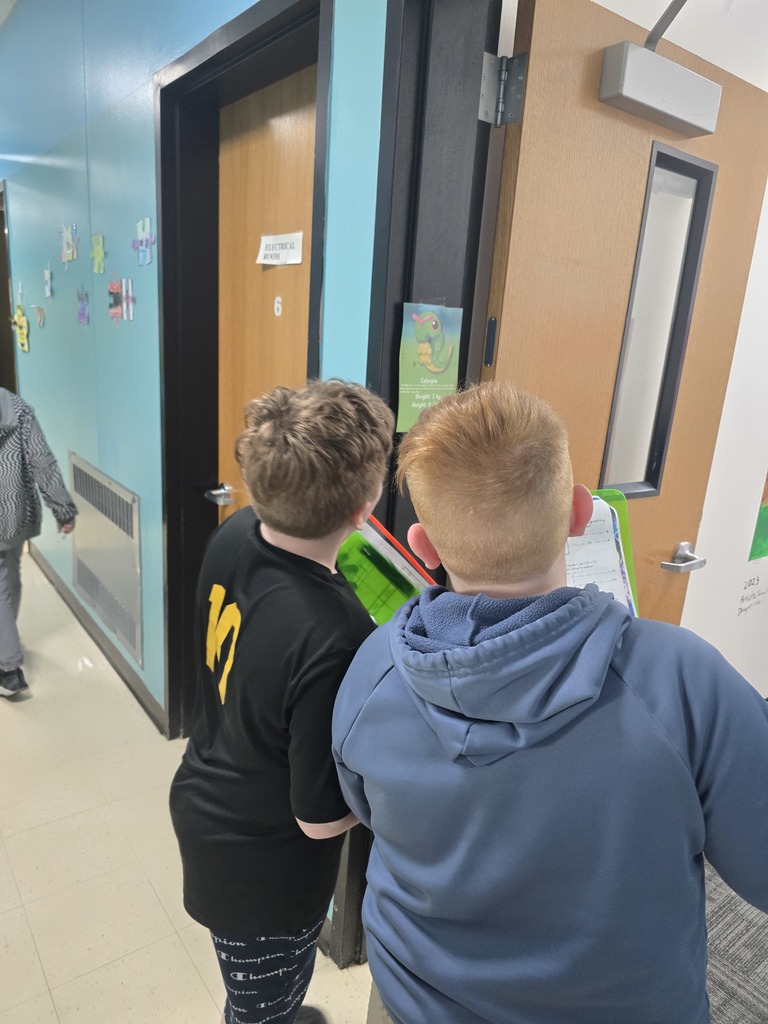 Image of students in a school hallway looking for Pokemon for a math assignment