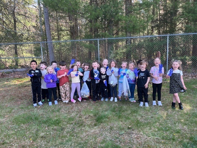 Image of student participating in a litter pluck for Earth Day on school grounds