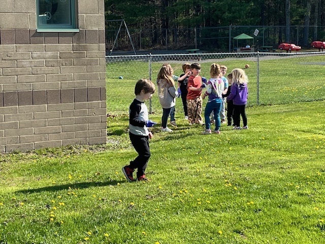Image of student participating in a litter pluck for Earth Day on school grounds