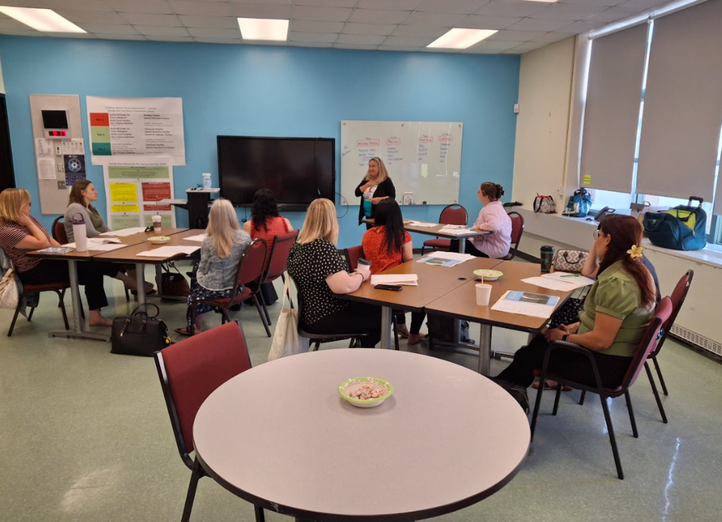 A group of educators sit in a professional development session