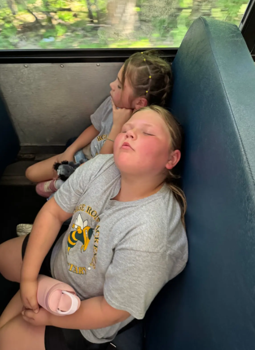 Students sleeping in on the school bus on their way back from the aquarium