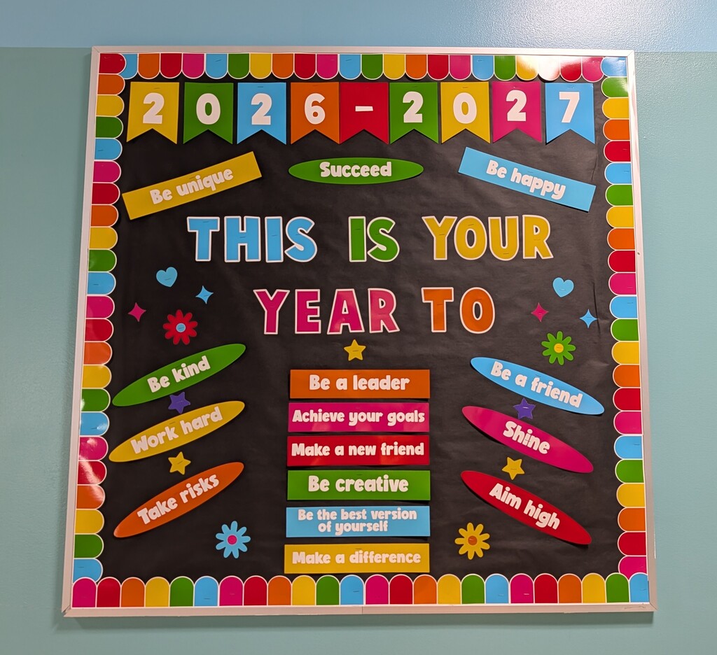 Image of a colorful bulletin board that read "This is your Year To..." with positive words to complete the sentence