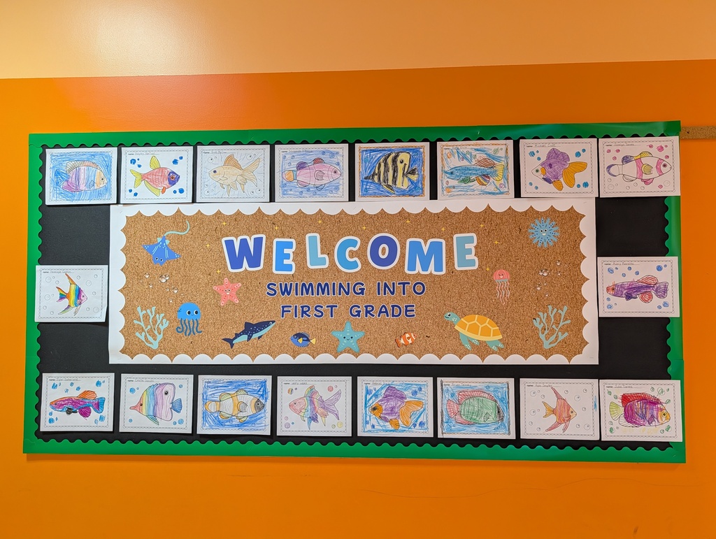 Image of a bulletin board decorated with fish that says "Welcome, Swimming into first grade."