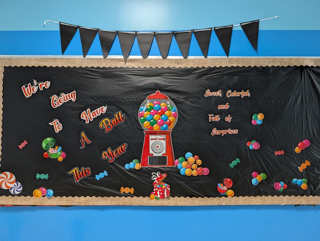 Image of a bulletin board that says "We're going to have a ball this year" with a picture of a gumball machine