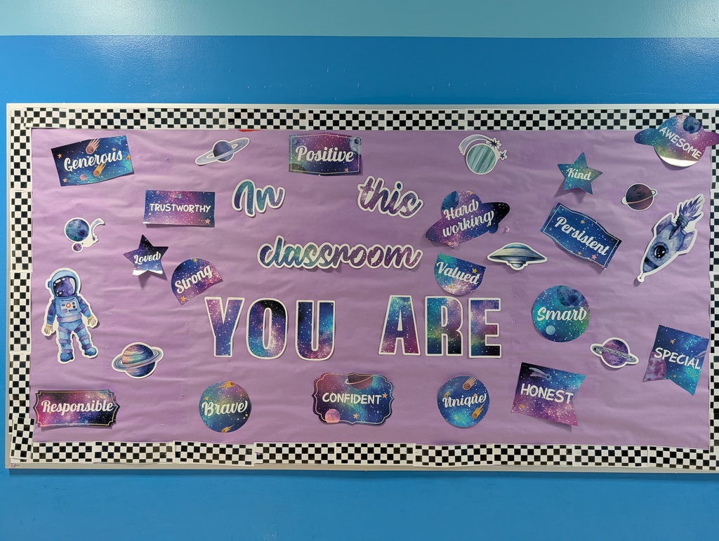 Image of a bulletin board that says "in this classroom you are..." with positive words to fill in the blank