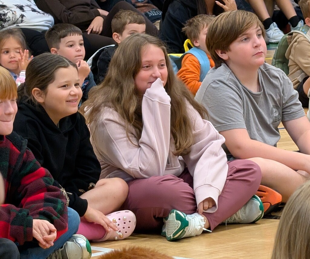 Image of students sitting on a gym floor