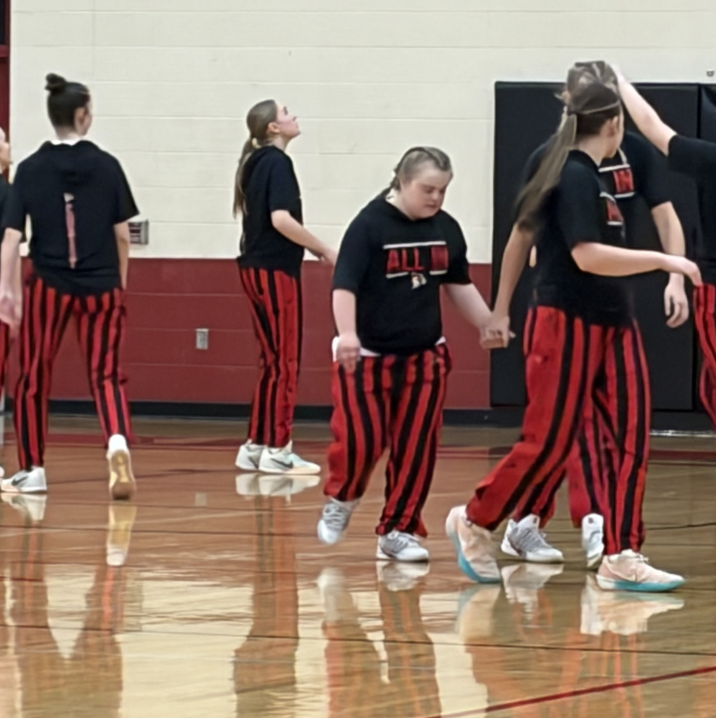 24–0. An undefeated regular season. But the most meaningful moment came when senior Clover made her debut, scoring six points as both teams and the crowd cheered her on.