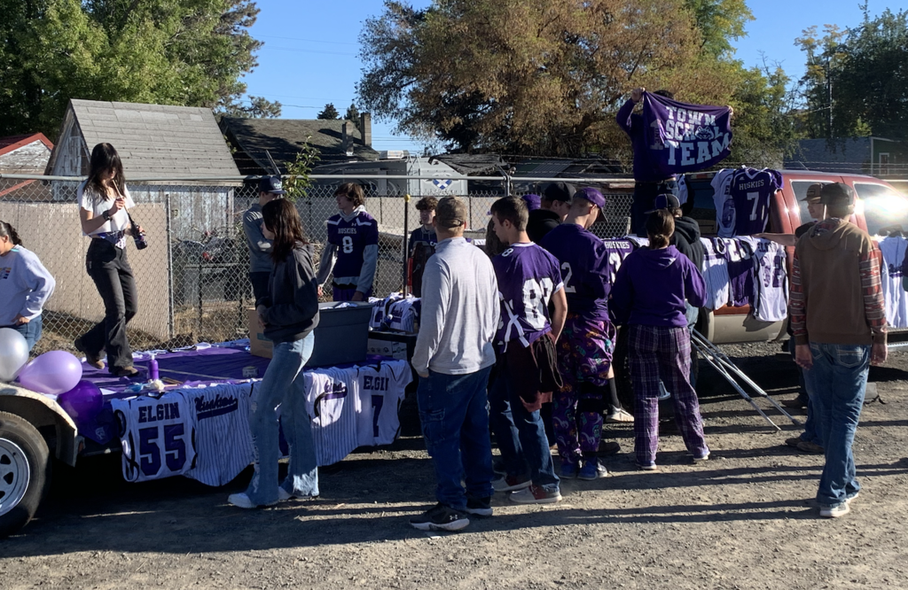 Students decorating parade float with jerseys and banners