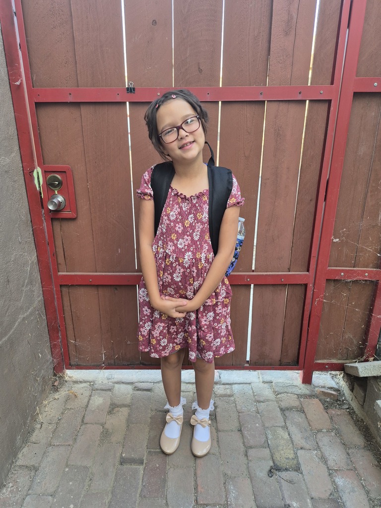 student in front of gate