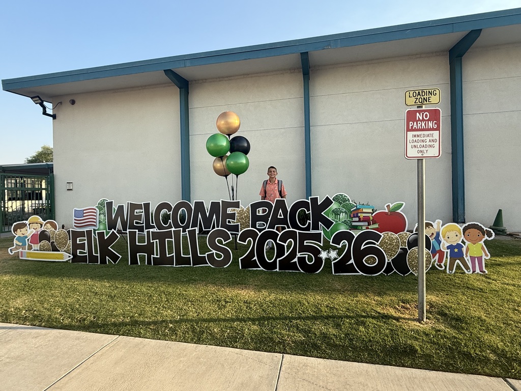 Student behind yard card