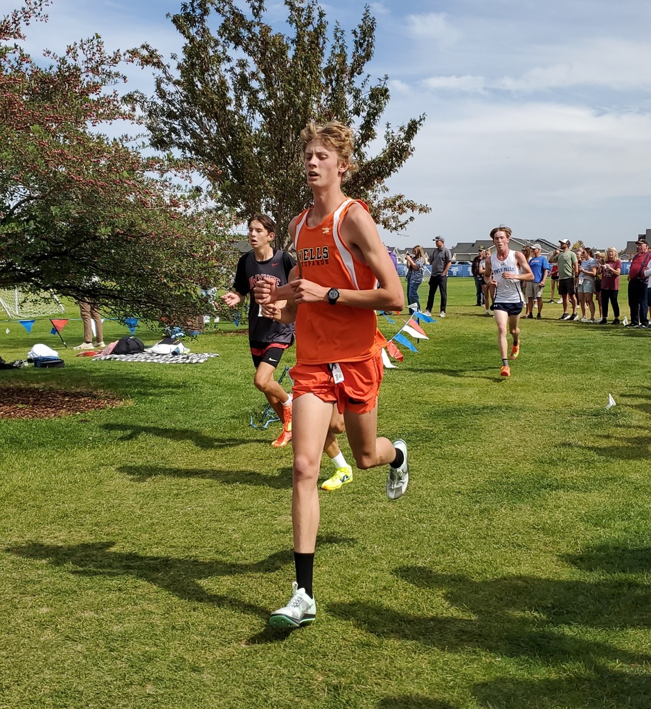 Wells High School cross country team members running in Jerome