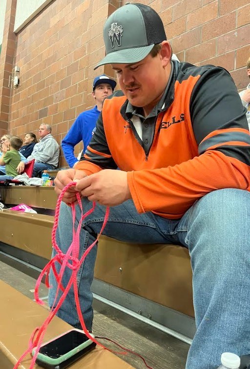 What wrestling coaches do when they are waiting for their athletes to compete