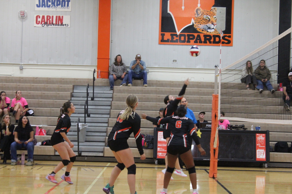 Wells JV volleyball girls playing in the gym in Wells