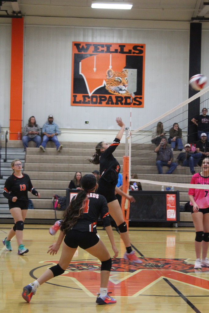 Wells JV volleyball girls playing in the gym in Wells