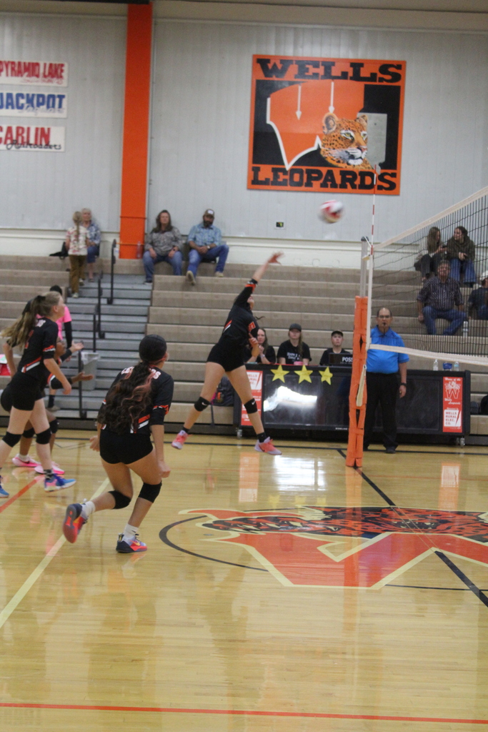 Wells JV volleyball girls playing in the gym in Wells
