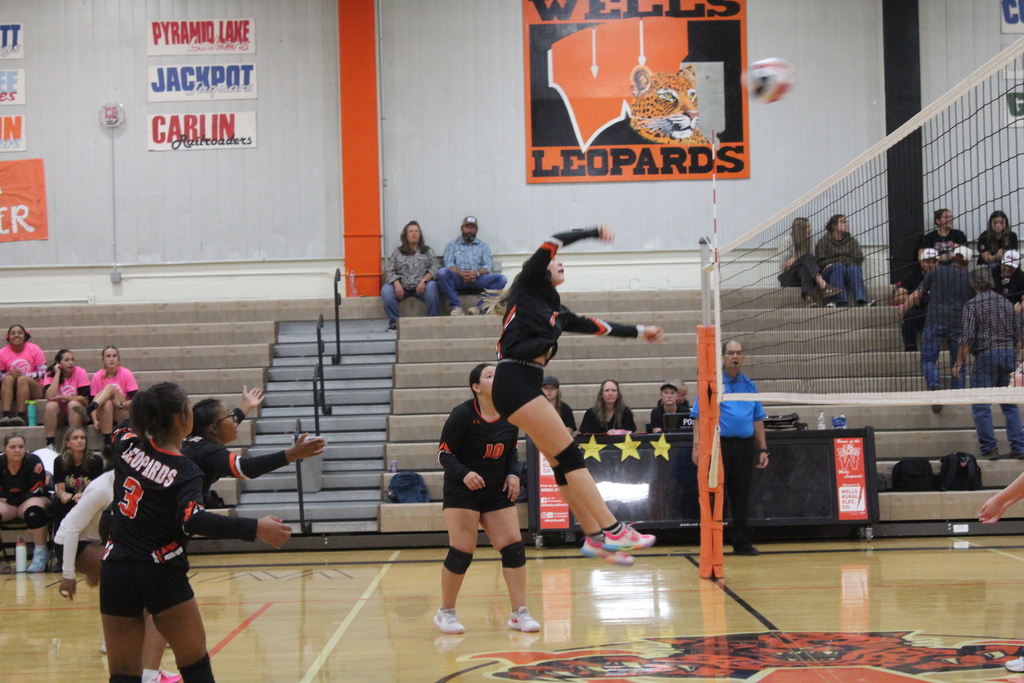 Wells JV volleyball girls playing in the gym in Wells
