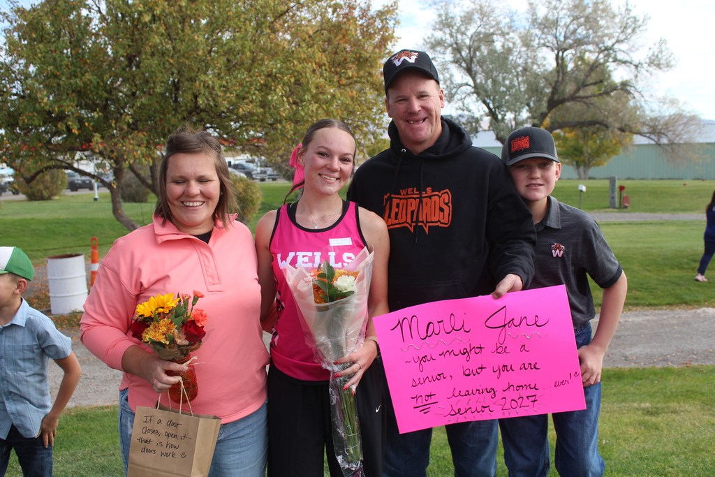 12th grade cross country runners with their families