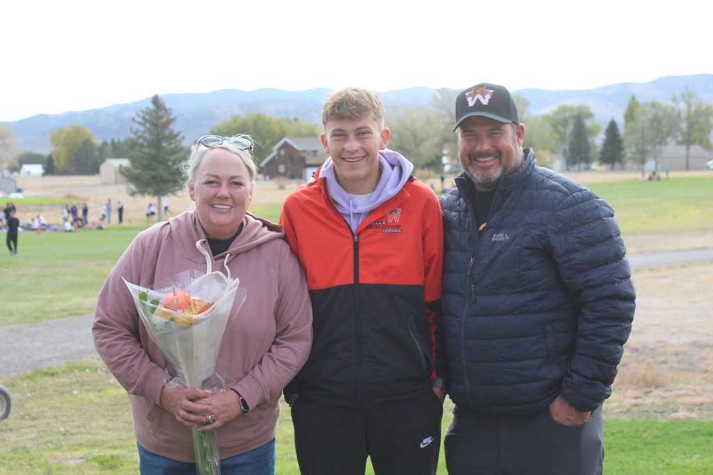 12th grade cross country runners with their families