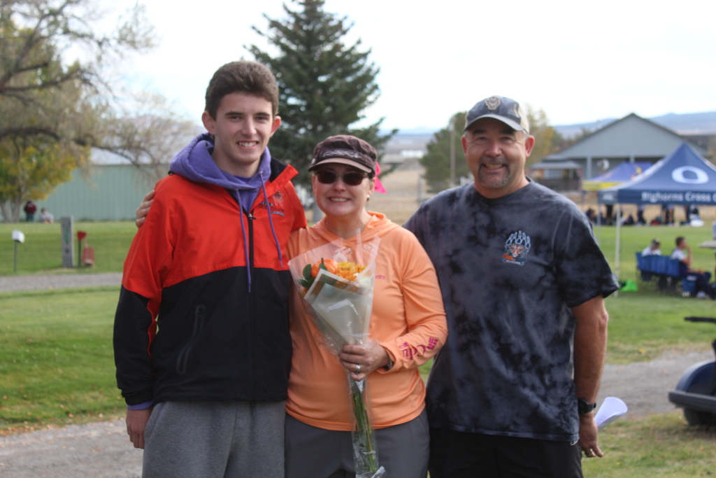 12th grade cross country runners with their families
