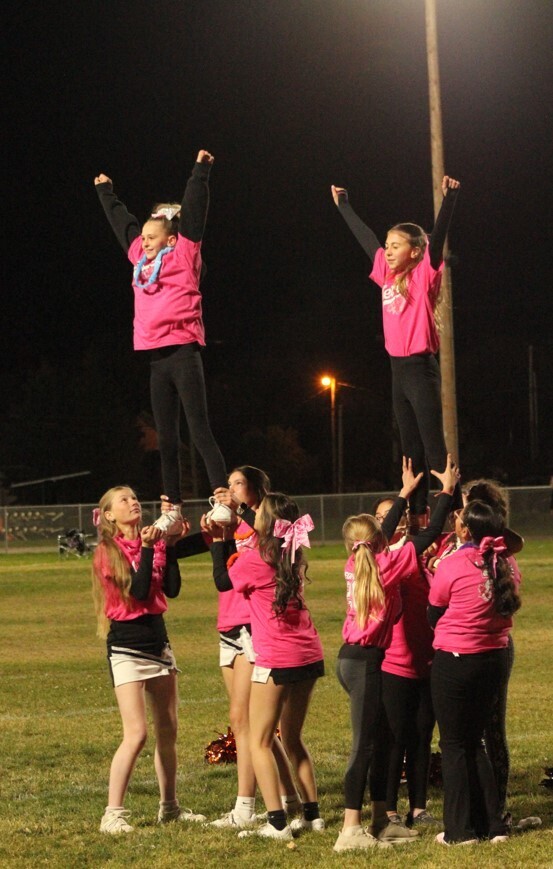 Wells High cheerleaders working with the mini cheerleaders during half time of the Wells Leopards vs Pyramid Lake Lakers football game