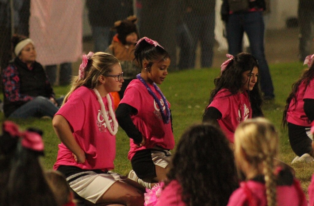 Wells High cheerleaders working with the mini cheerleaders during half time of the Wells Leopards vs Pyramid Lake Lakers football game