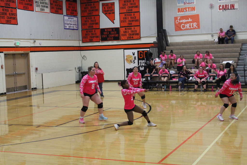 Wells High School JV girls volleyball team members playing against the Lund High School JV volleyball girls