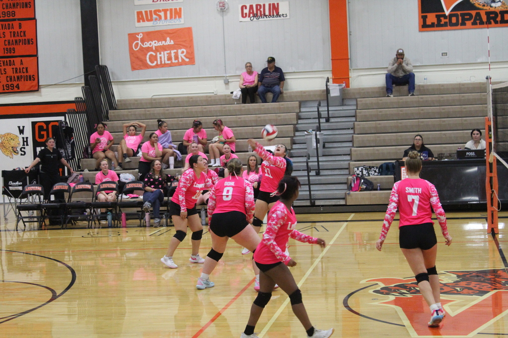 Wells High School JV girls volleyball team members playing against the Lund High School JV volleyball girls