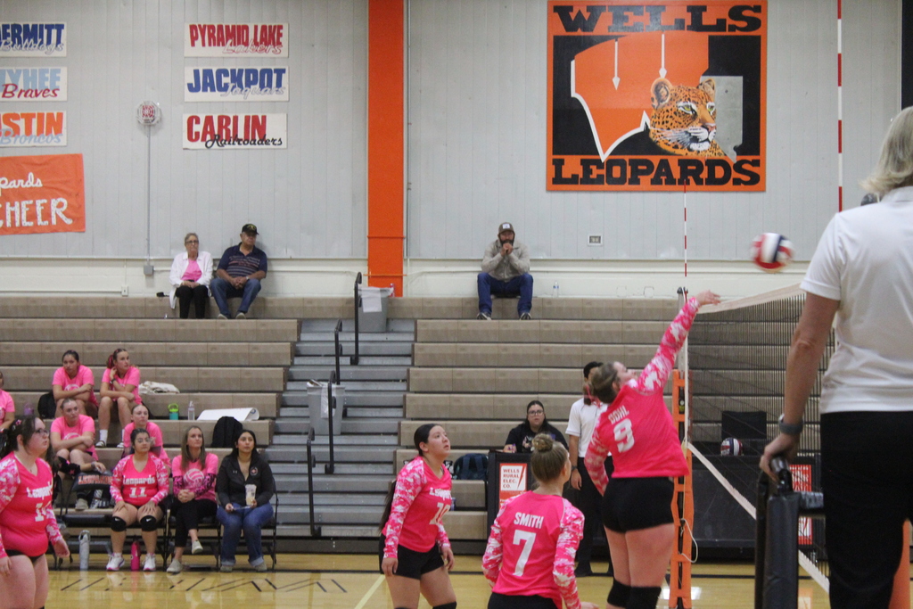 Wells High School JV girls volleyball team members playing against the Lund High School JV volleyball girls