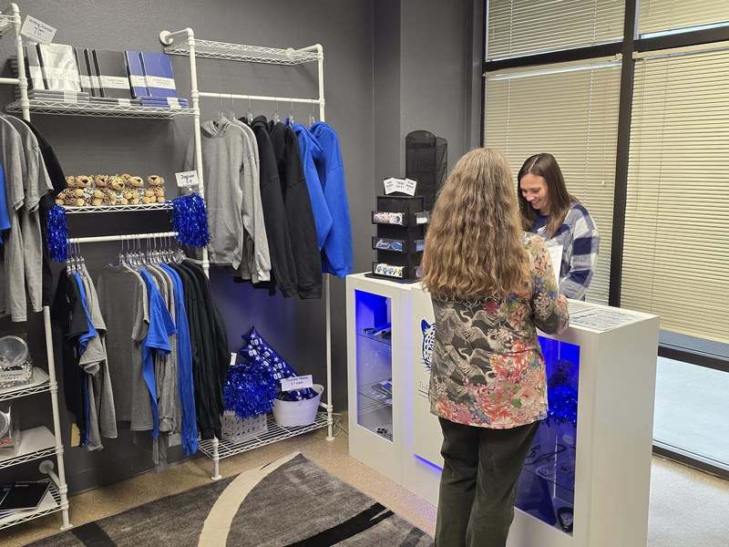 Teacher Katie Estrada behind register