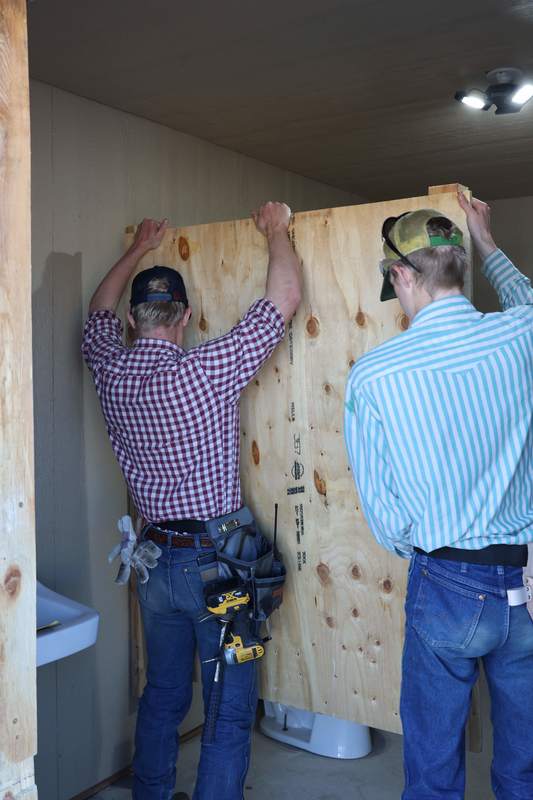 Students rebuild bathroom stalls