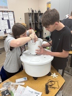 Coe and Leelyn, 8th grade, work to assemble the hydroponic tower