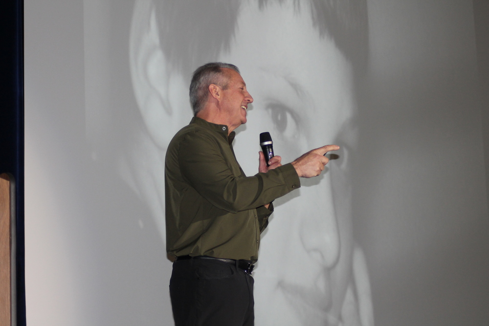 Speaker in front of powerpoint