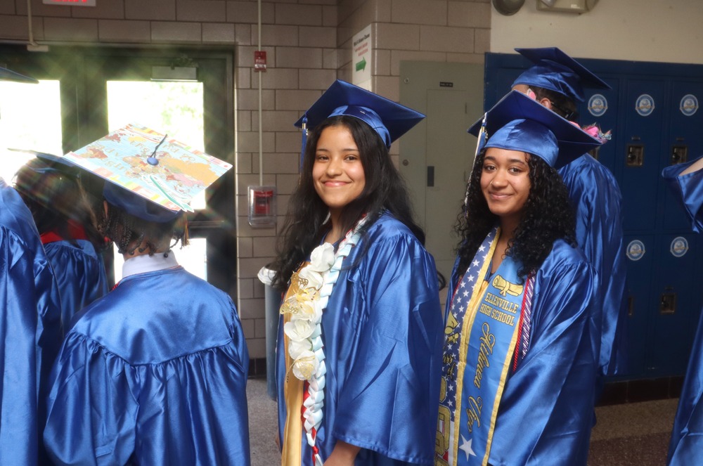 Graduates standing in a line in the hallway