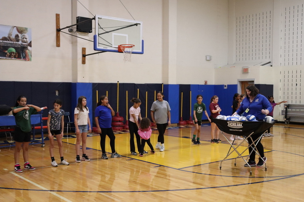 girls lining up to practice volleyball