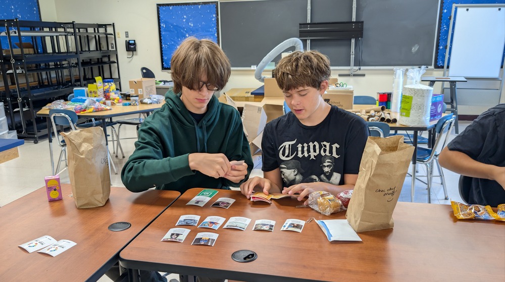 Two students working together at a table