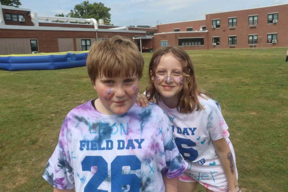 Two students outside wearing field day shirts