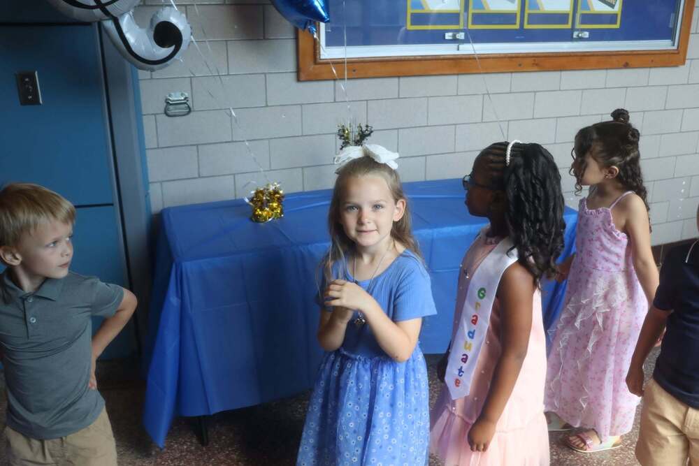 A student smiling in a line