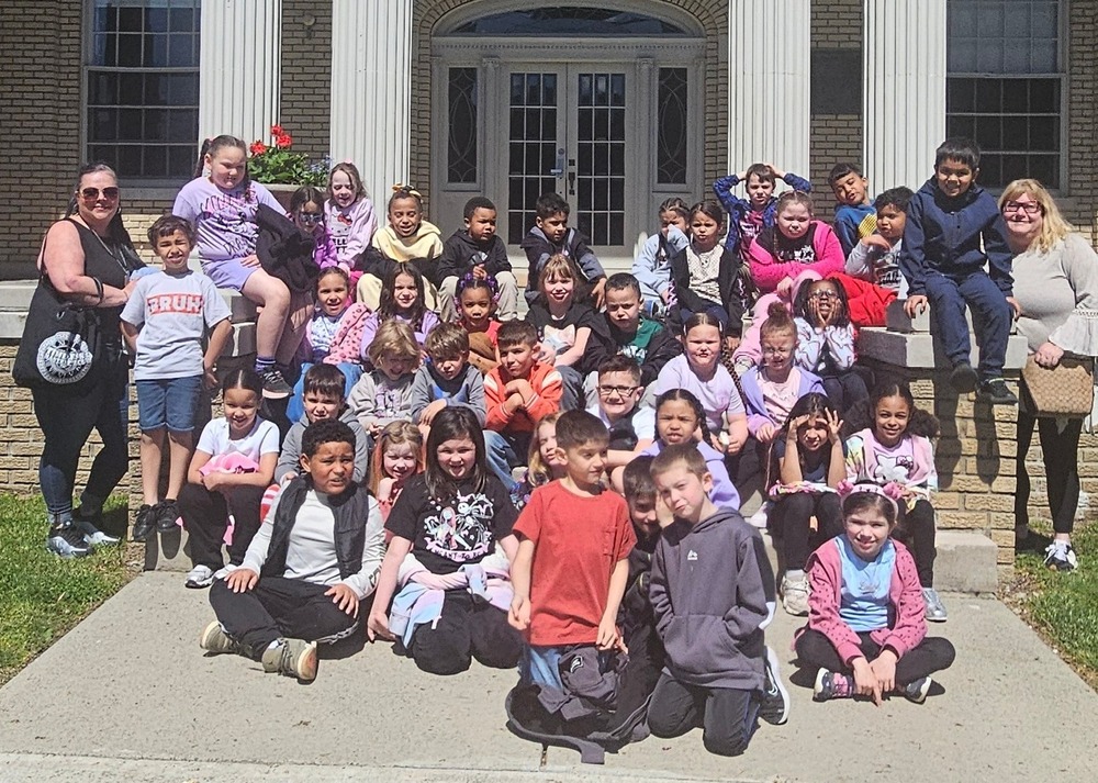 Class photo in front of a building