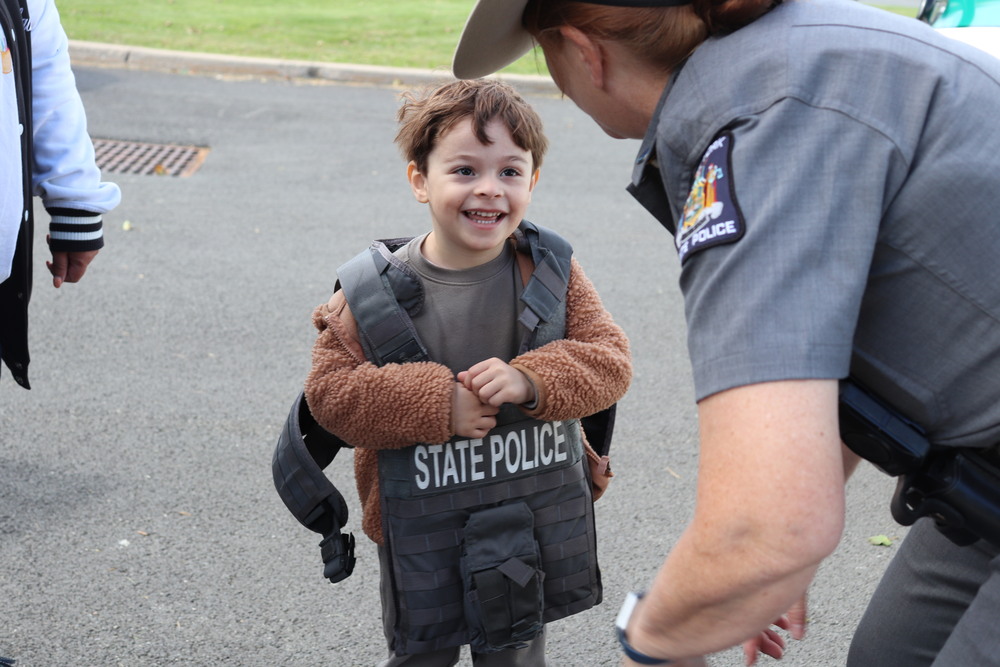 A young student tries on a police vest