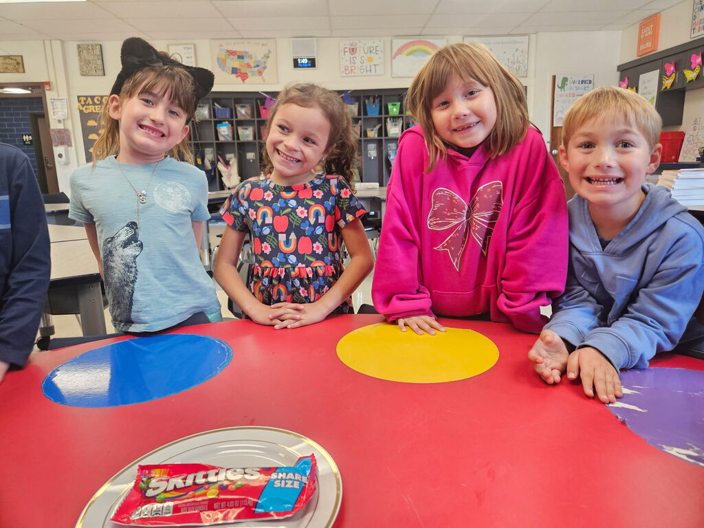 Students posing with skittles