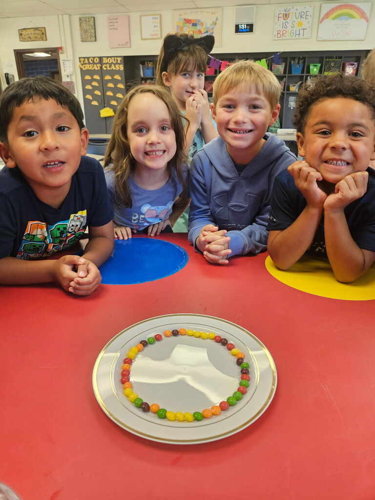 Students posing with their skittles experiment